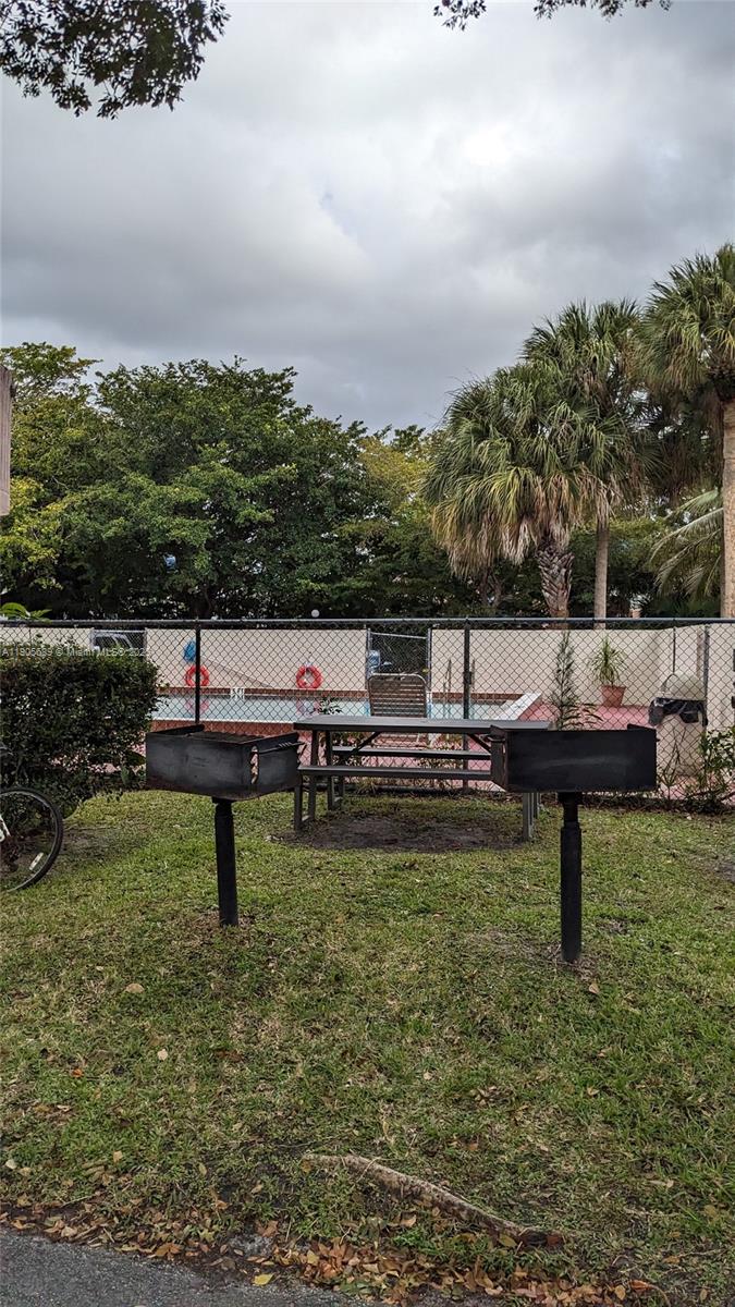 2701 Riverside Drive, Unit 206B Coral Springs, FL 33065 - Photo 12 of 19 a view of a lake with outdoor sitting area