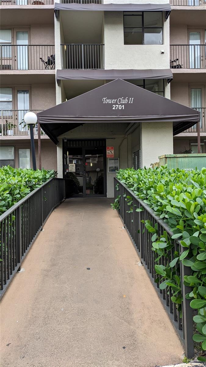 2701 Riverside Drive, Unit 206B Coral Springs, FL 33065 - Photo 15 of 19 a front view of a house with a garden