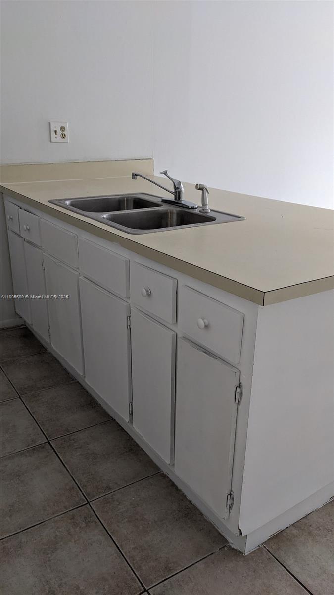 2701 Riverside Drive, Unit 206B Coral Springs, FL 33065 - Photo 2 of 19 a view of cabinets and sink