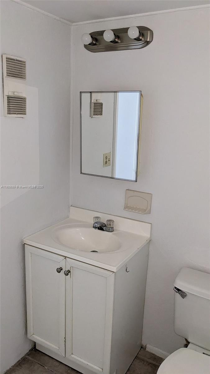 2701 Riverside Drive, Unit 206B Coral Springs, FL 33065 - Photo 4 of 19 a bathroom with a sink a toilet and mirror
