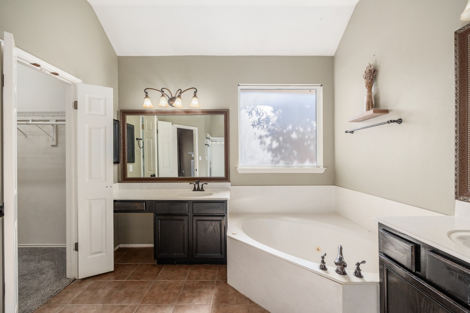 1108 Antelope Ridge Cedar Park, TX 78613 - Photo 12 of 39 A vaulted ceiling rises above a deep soaking tub and dual vanities.