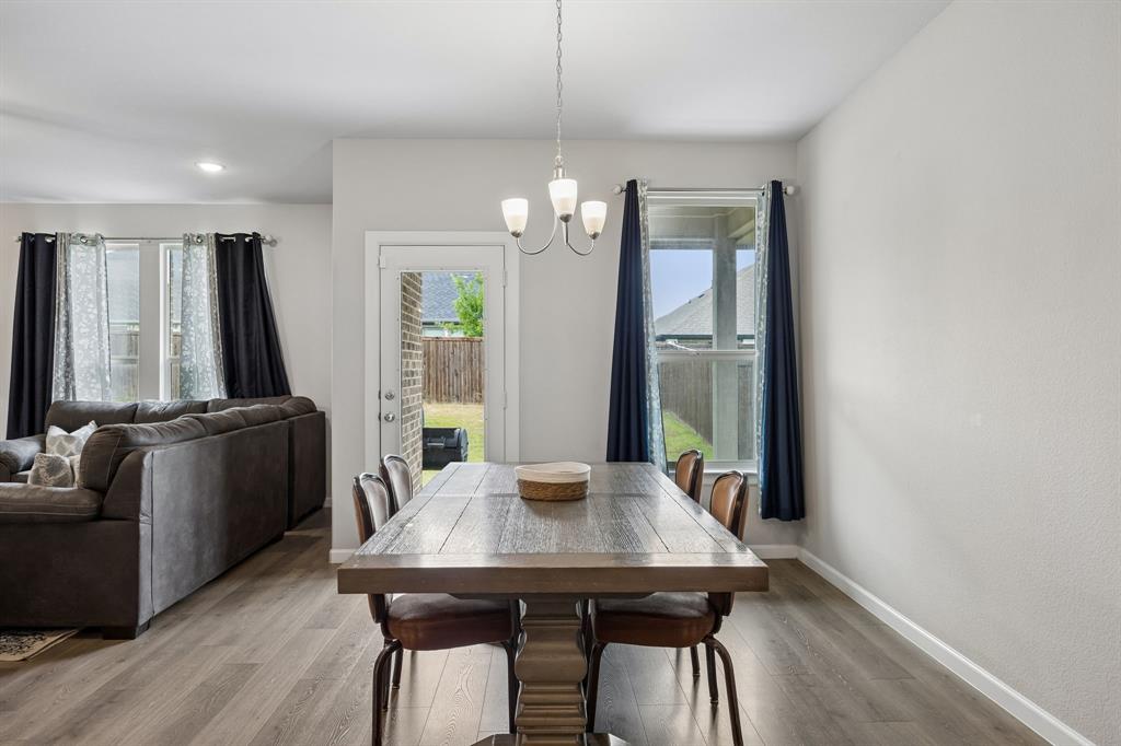 638 Hazeltine Road Red Oak, TX 75154 - Photo 13 of 29 a view of a dining room with furniture window and wooden floor