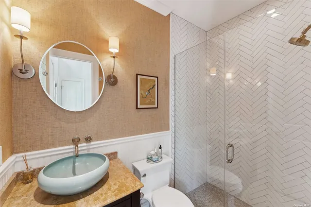 a bathroom with a toilet a sink and mirror