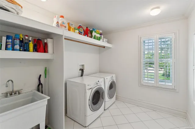a utility room with dryer washer and a window