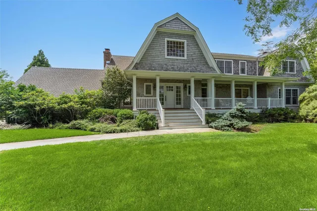 an aerial view of a residential houses with outdoor space and street view
