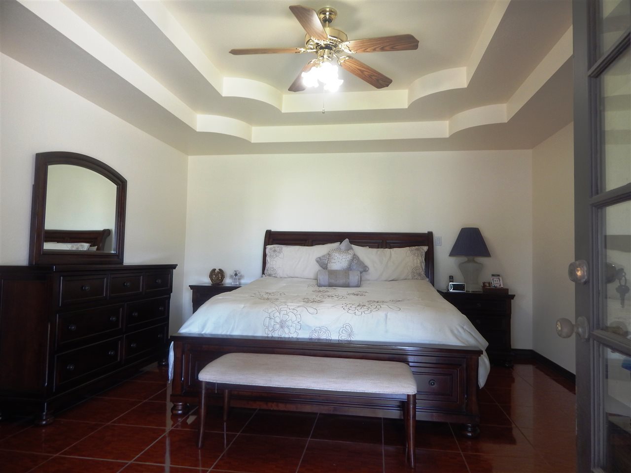 415 Cayman Court Laredo, TX 78045 - Photo 7 of 18 a bedroom with a bed and a dresser with mirror