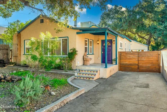 a view of a house with large windows and a yard