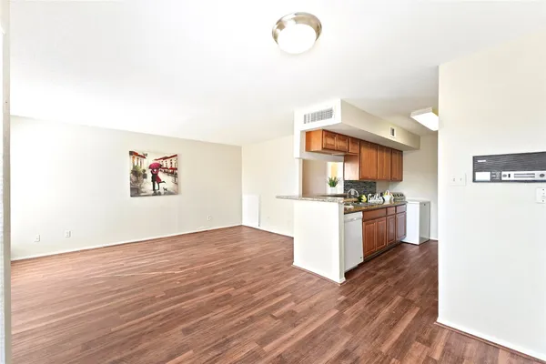 a kitchen with granite countertop a stove and a refrigerator