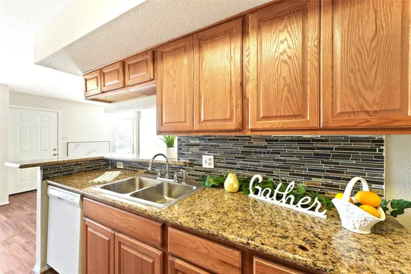 a kitchen with a sink a stove and cabinets