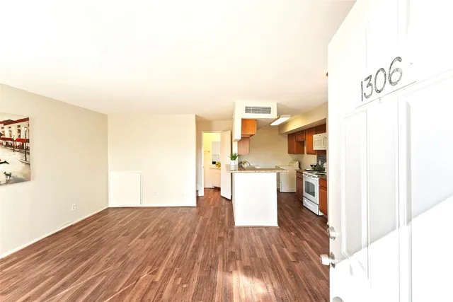 a view of a kitchen with wooden floor