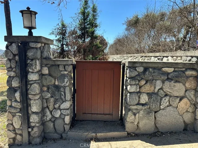 a view of a wooden door and brick wall