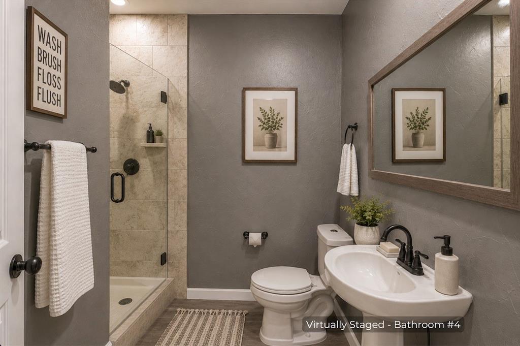 15 Trail Ridge Drive Melissa, TX 75454 - Photo 29 of 38 Bathroom featuring a pedestal sink with a matte black faucet, a framed mirror, and a walk-in shower with clear glass enclosure and tiled walls