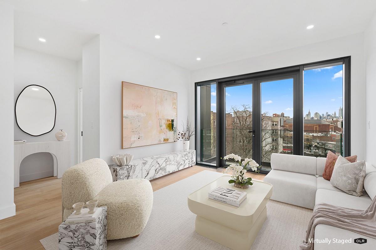 45-29 47th Street, Unit 3A Queens, NY 11377 - Photo 2 of 6 a living room with furniture and a large window