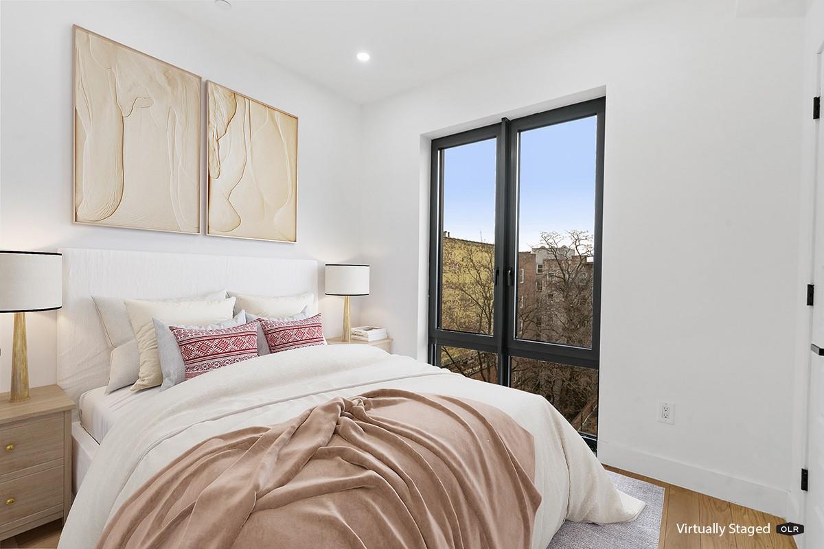 45-29 47th Street, Unit 3A Queens, NY 11377 - Photo 5 of 6 a bedroom with a large bed and a large window