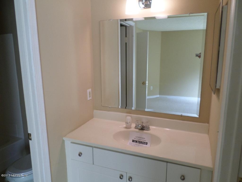 10200 Belle Rive Boulevard, Unit 69 Jacksonville, FL 32256 - Photo 11 of 17 a bathroom with a sink and a mirror
