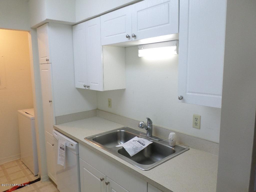 10200 Belle Rive Boulevard, Unit 69 Jacksonville, FL 32256 - Photo 4 of 17 a kitchen with a sink and cabinets