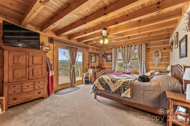 a bed sitting in a spacious bedroom next to a window