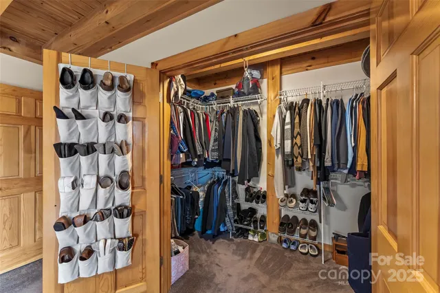 a view of walk in closet with clothes