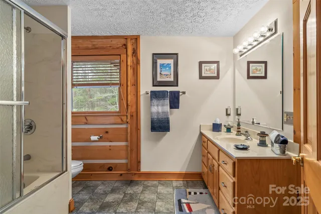 a view of a dining room with furniture chandelier and a rug
