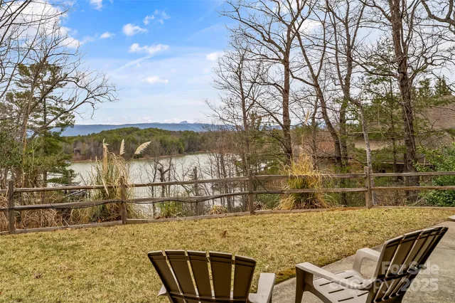an aerial view of a house with a yard and lake view