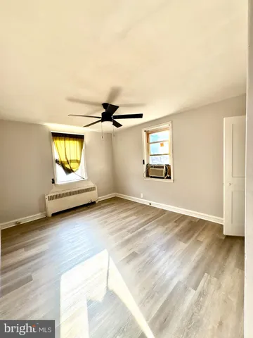 a view of a room with wooden floor and window