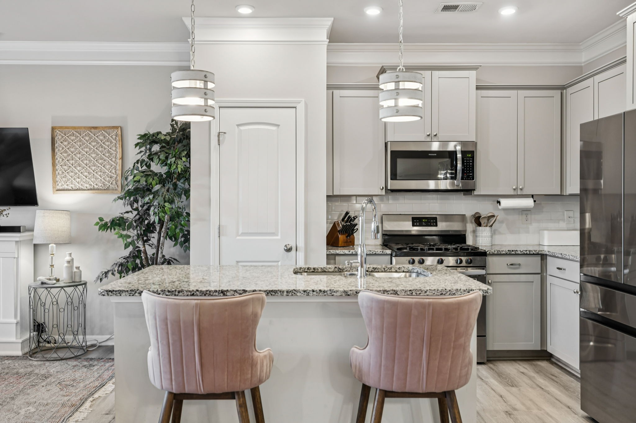 1077 Watermark Way Mount Juliet, TN 37122 - Photo 11 of 51 a kitchen with stainless steel appliances granite countertop a stove a sink a microwave a refrigerator and chairs