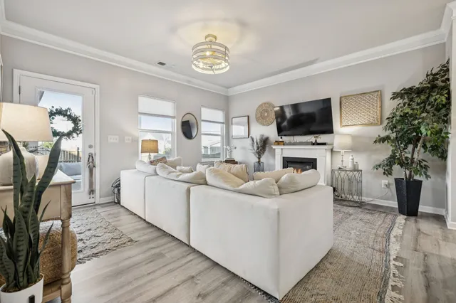 a living room with furniture a flat screen tv and a fireplace
