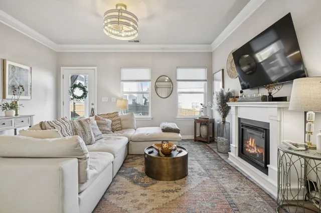 a dining room with furniture a chandelier and wooden floor