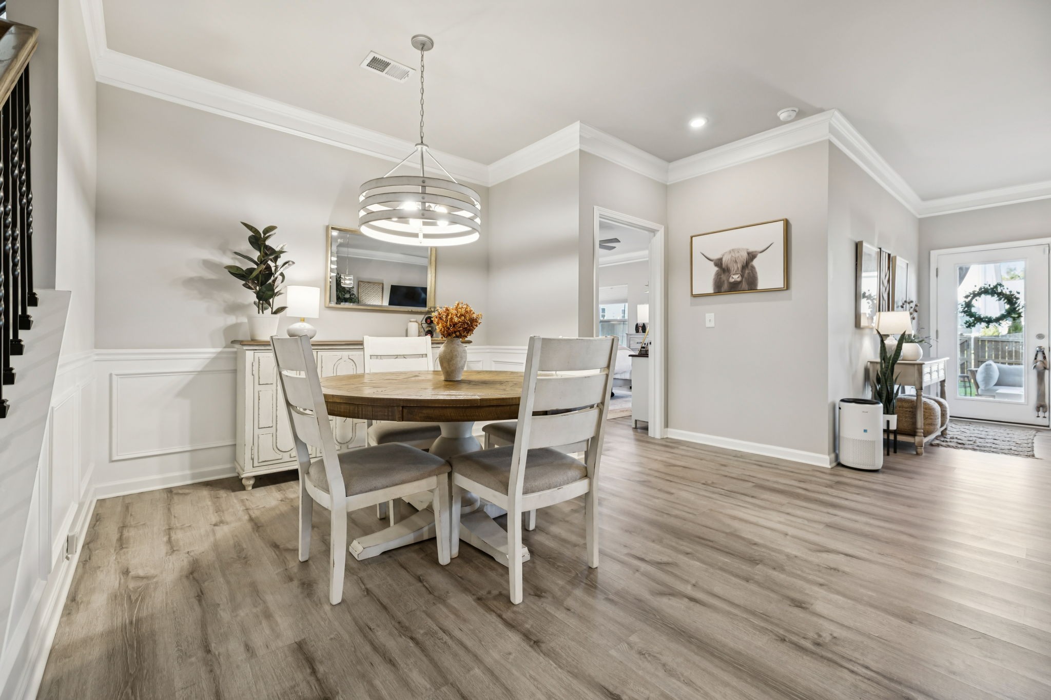 1077 Watermark Way Mount Juliet, TN 37122 - Photo 18 of 51 a dining room with wooden floor a chandelier a wooden table and chairs