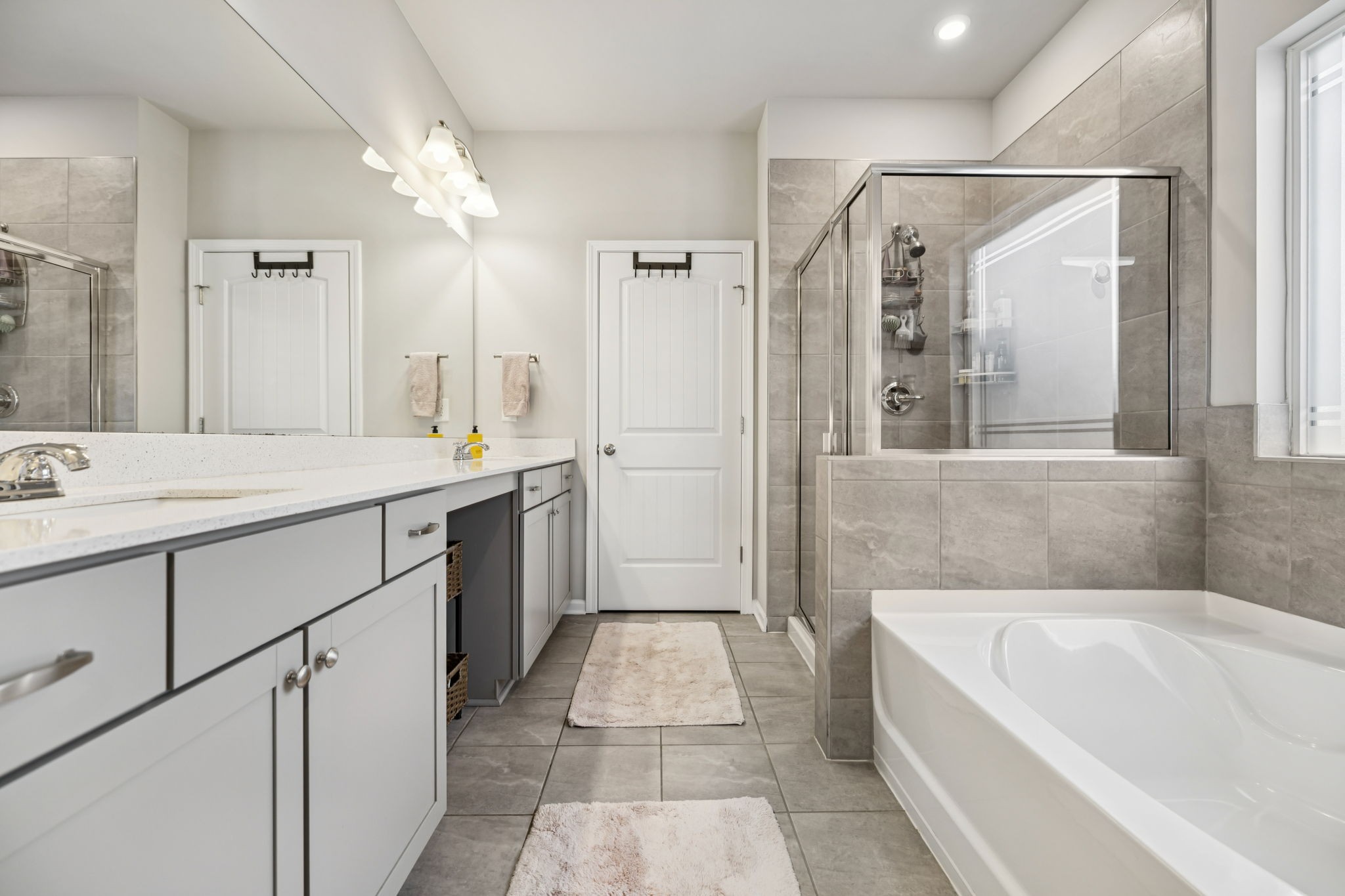 1077 Watermark Way Mount Juliet, TN 37122 - Photo 22 of 51 a bathroom with a tub a sink and a mirror