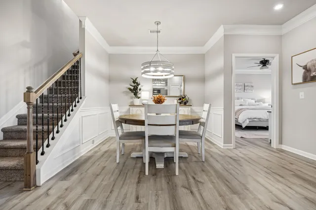 a view of a dining room with furniture and wooden floor