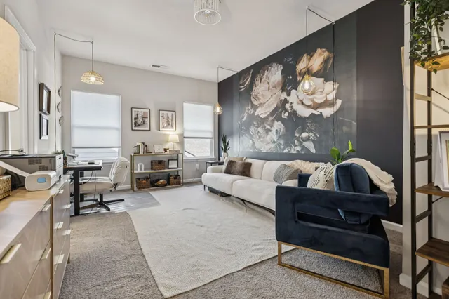 a living room with furniture and a large mirror