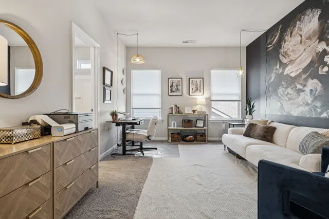 a living room with furniture a couch and dresser