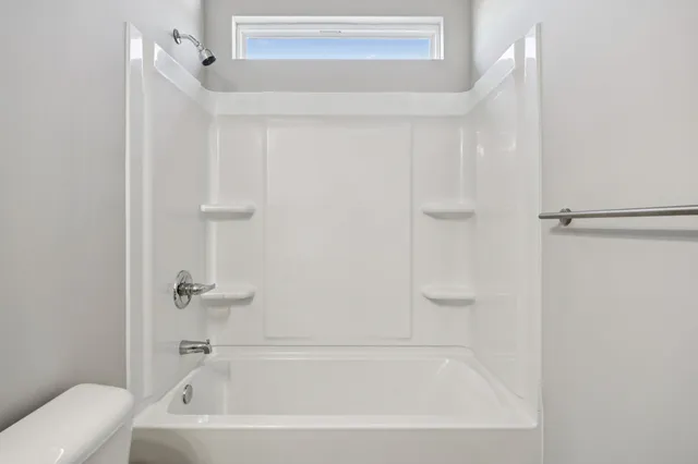 a bedroom with a bed and a lamp