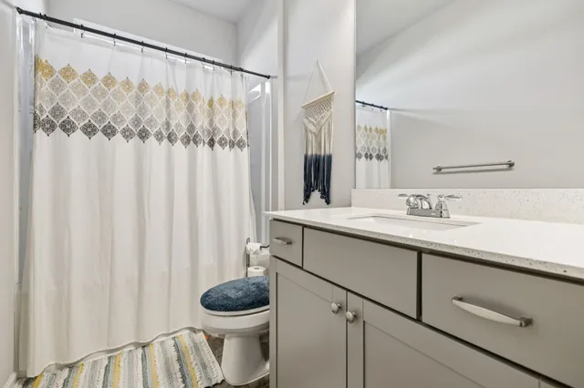 a living room with furniture and a book shelf