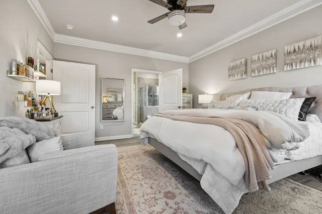 a spacious bedroom with a bed and ceiling fan