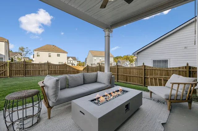 a view of a house with a backyard porch and sitting area