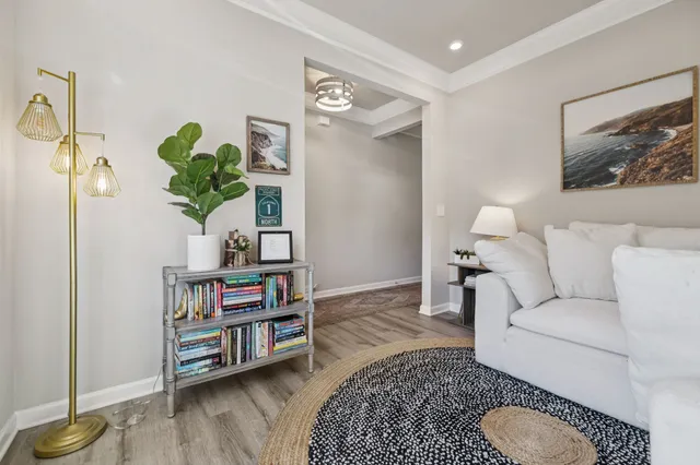 a living room with furniture and a wooden floor