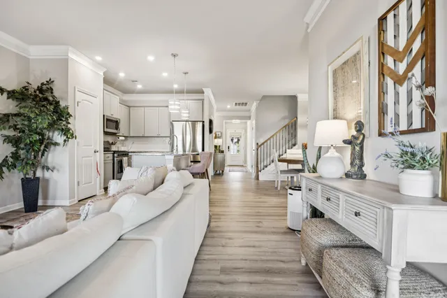a large white kitchen with cabinets a sink and a potted plant