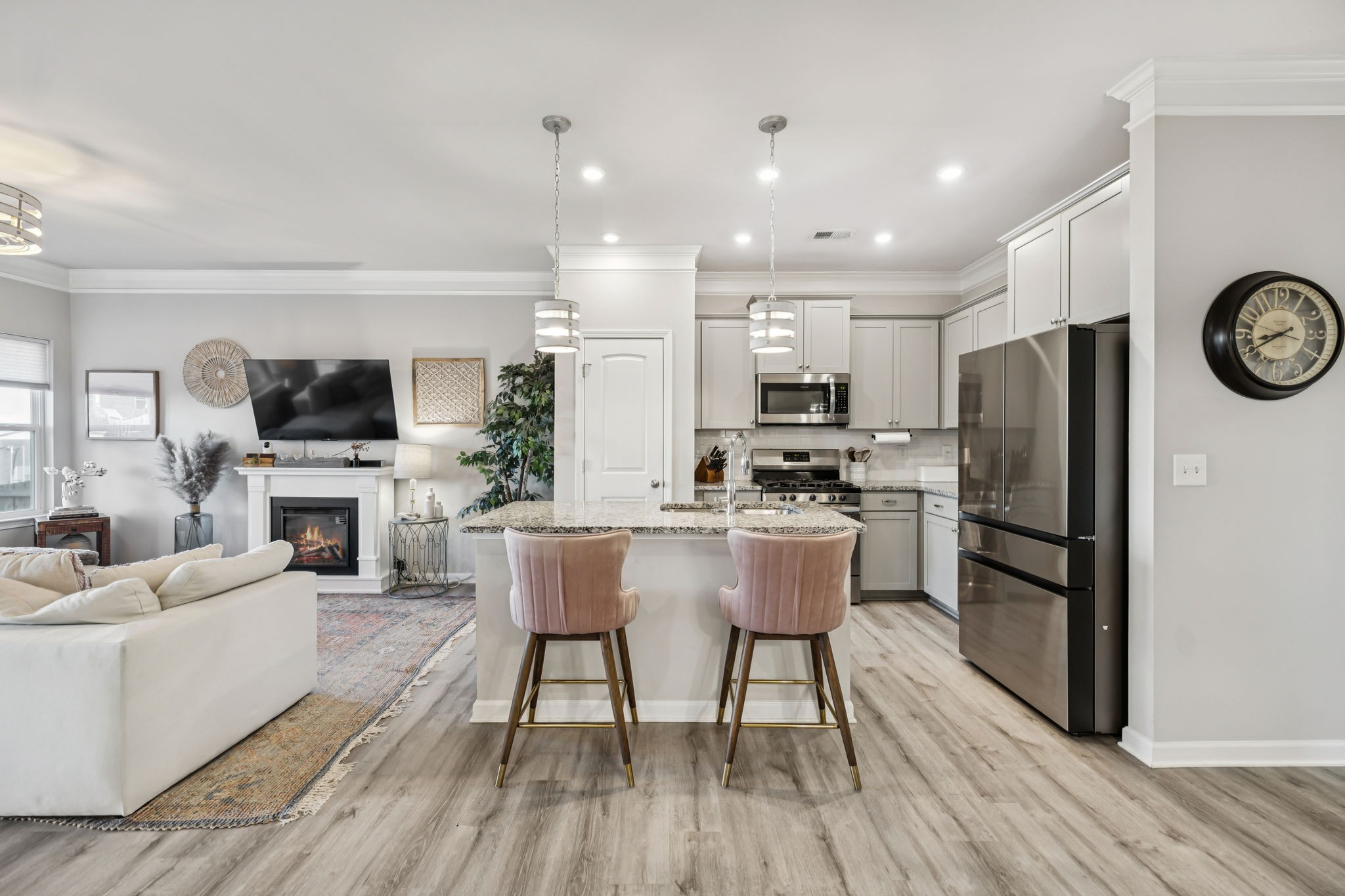 1077 Watermark Way Mount Juliet, TN 37122 - Photo 10 of 51 a kitchen with stainless steel appliances a refrigerator a stove top oven a sink dishwasher a dining table and chairs with wooden floor