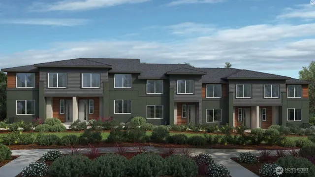 a front view of a residential apartment building with a yard