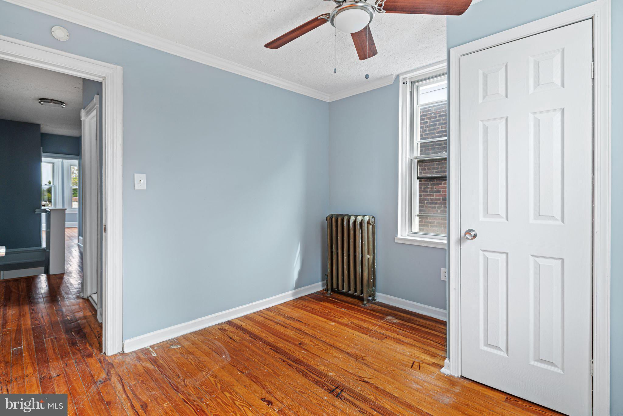 4606 Benner Street Philadelphia, PA 19135 - Photo 12 of 13 a view of empty room with wooden floor and fan