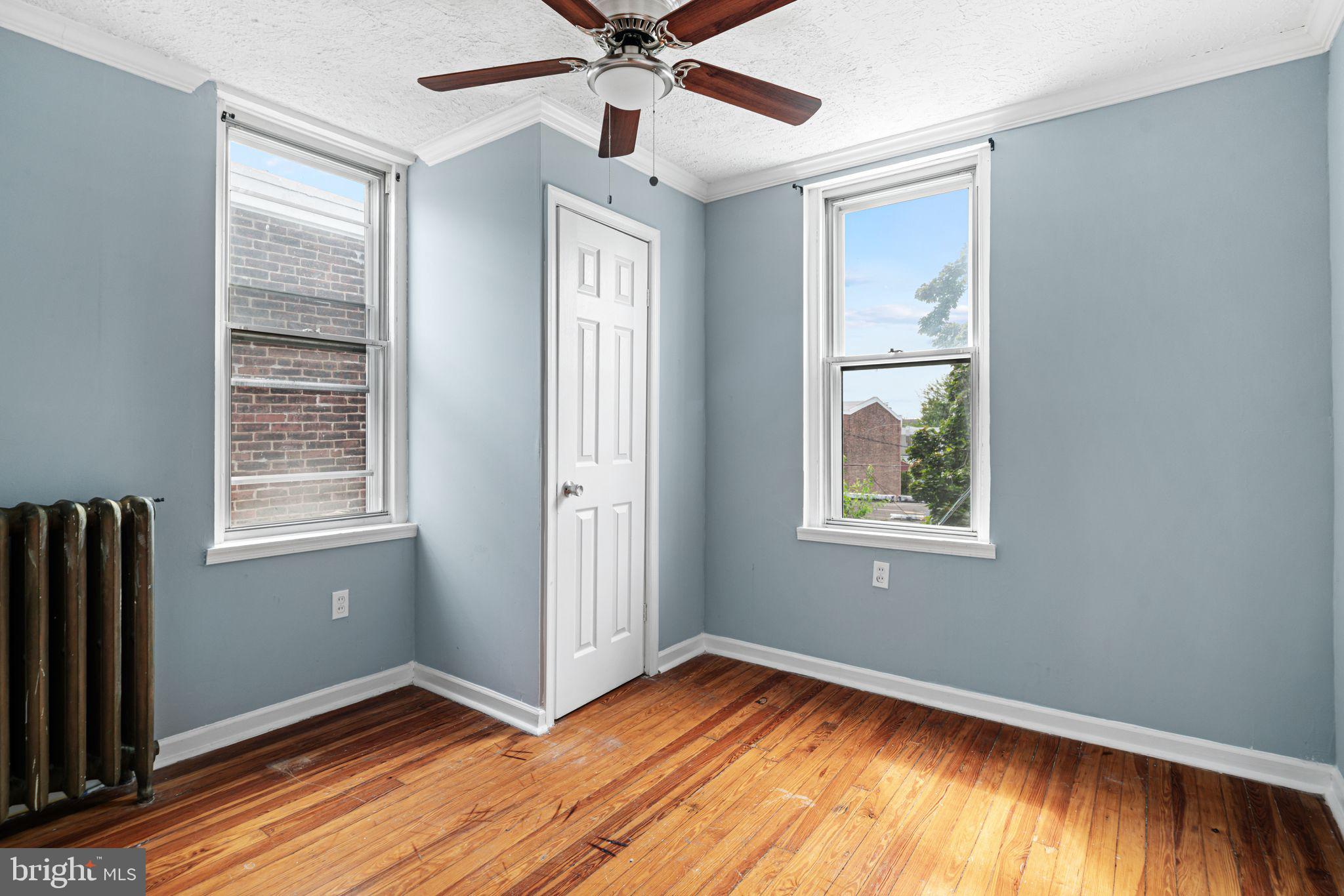 4606 Benner Street Philadelphia, PA 19135 - Photo 13 of 13 a view of an empty room with window and wooden floor