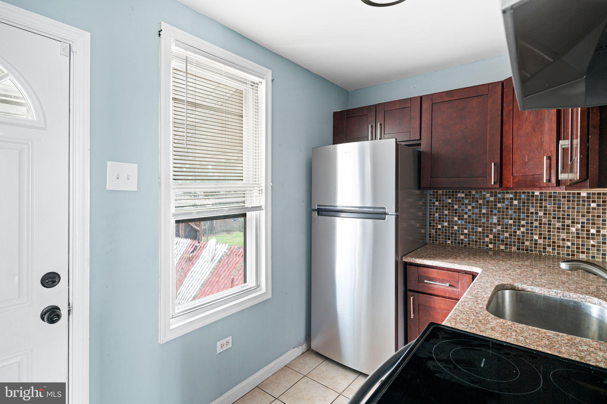 4606 Benner Street Philadelphia, PA 19135 - Photo 3 of 13 a kitchen with a refrigerator and a sink