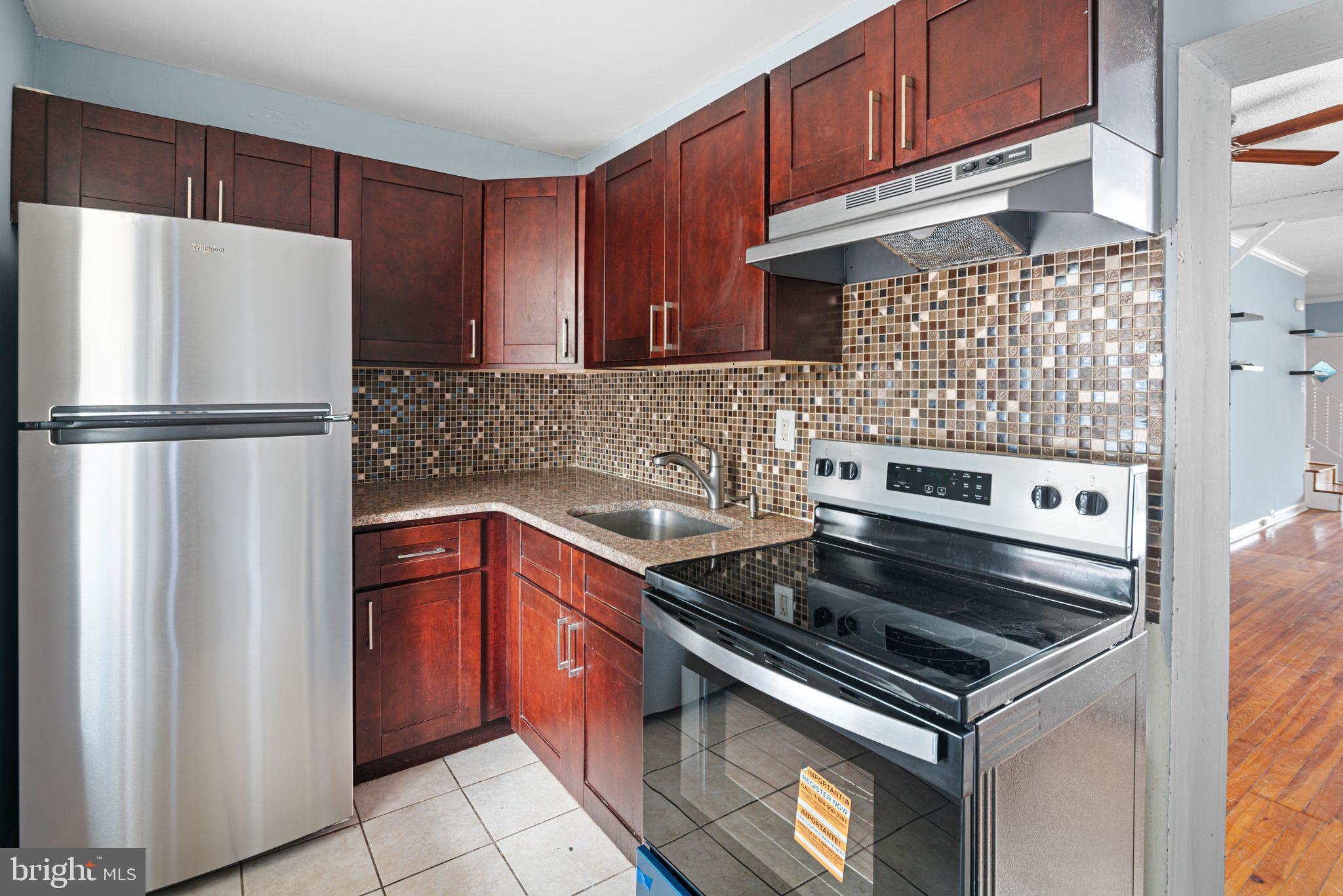 4606 Benner Street Philadelphia, PA 19135 - Photo 4 of 13 a kitchen with a refrigerator and a sink