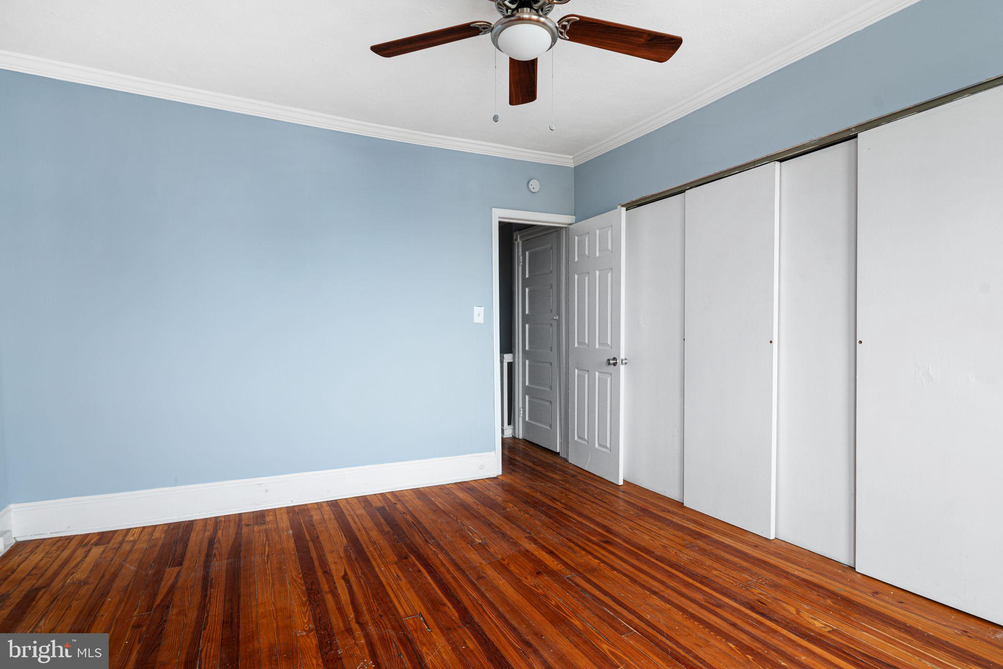 4606 Benner Street Philadelphia, PA 19135 - Photo 6 of 13 a view of a room with wooden floor ceiling fan and window