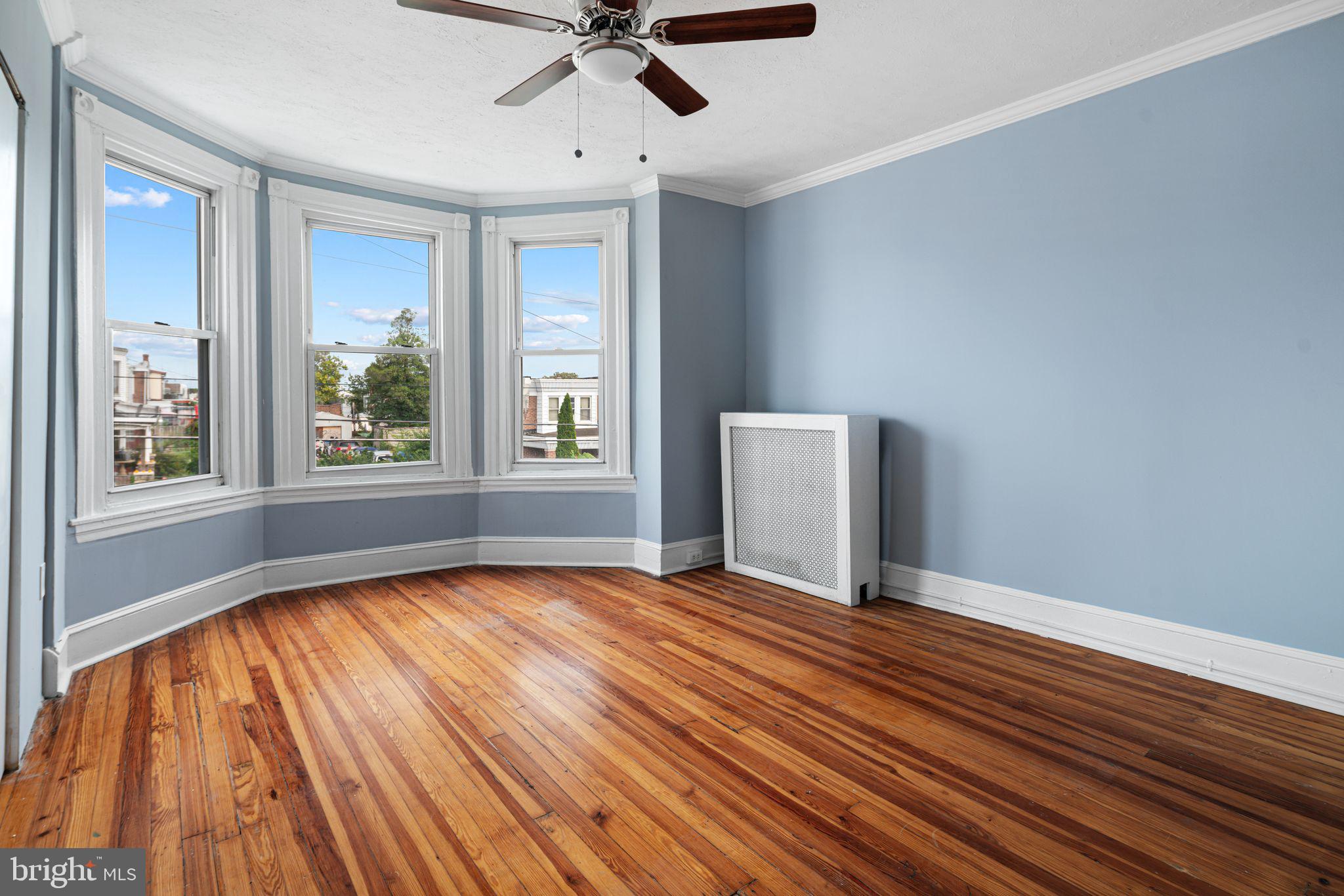 4606 Benner Street Philadelphia, PA 19135 - Photo 7 of 13 a view of an empty room with a window and wooden floor