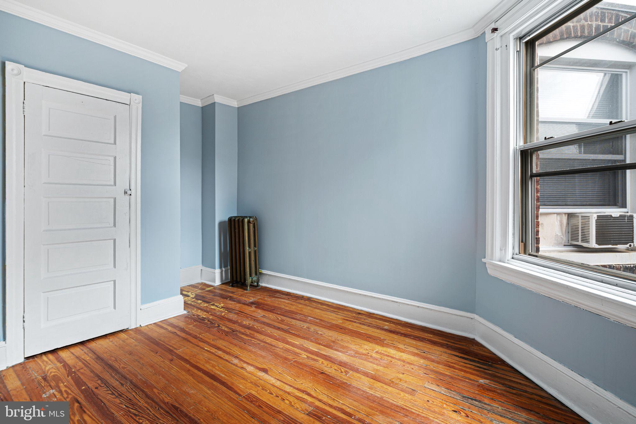 4606 Benner Street Philadelphia, PA 19135 - Photo 9 of 13 a bedroom with a bed and a window