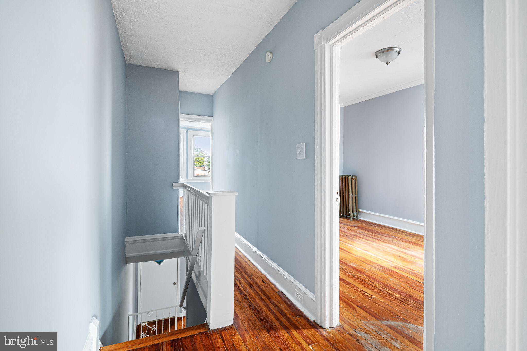 4606 Benner Street Philadelphia, PA 19135 - Photo 10 of 13 a view of hallway with sink and wooden floor