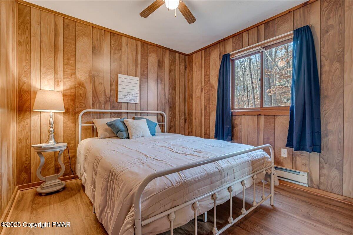1037 Porter Drive Bushkill, PA 18324 - Photo 13 of 45 a bedroom with a bed and wooden floor